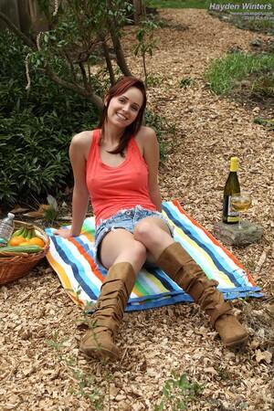 Hayden Winters by herself in the forest with a bottle of wine